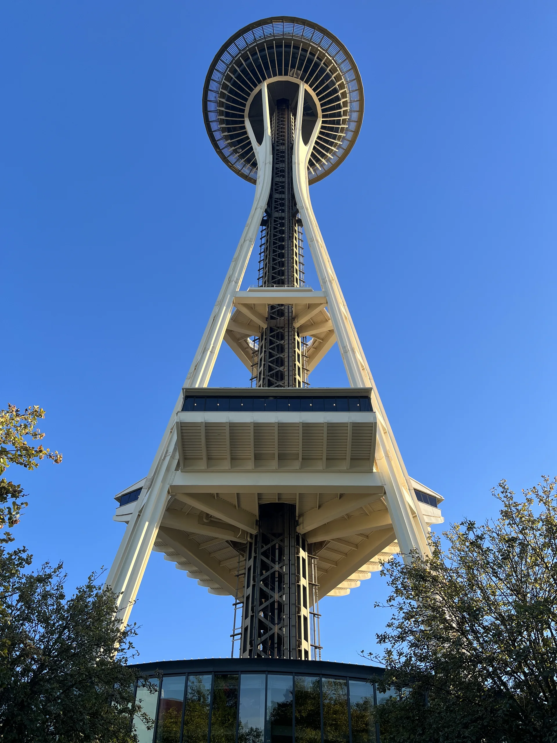 Vista de baixo para cima da Space Needle contra um céu azul em Seattle.