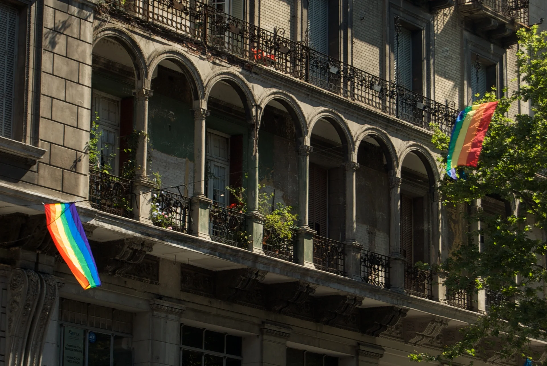 Bandeiras arco-íris em fachadas de edifício histórico na Avenida de Mayo, em Buenos Aires