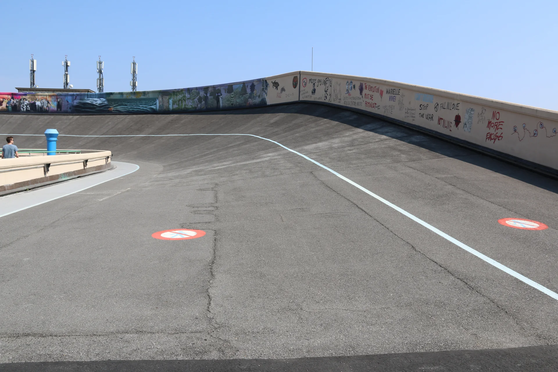 Curva íngreme da pista de testes no telhado do Lingotto com linha azul e murais no parapeito
