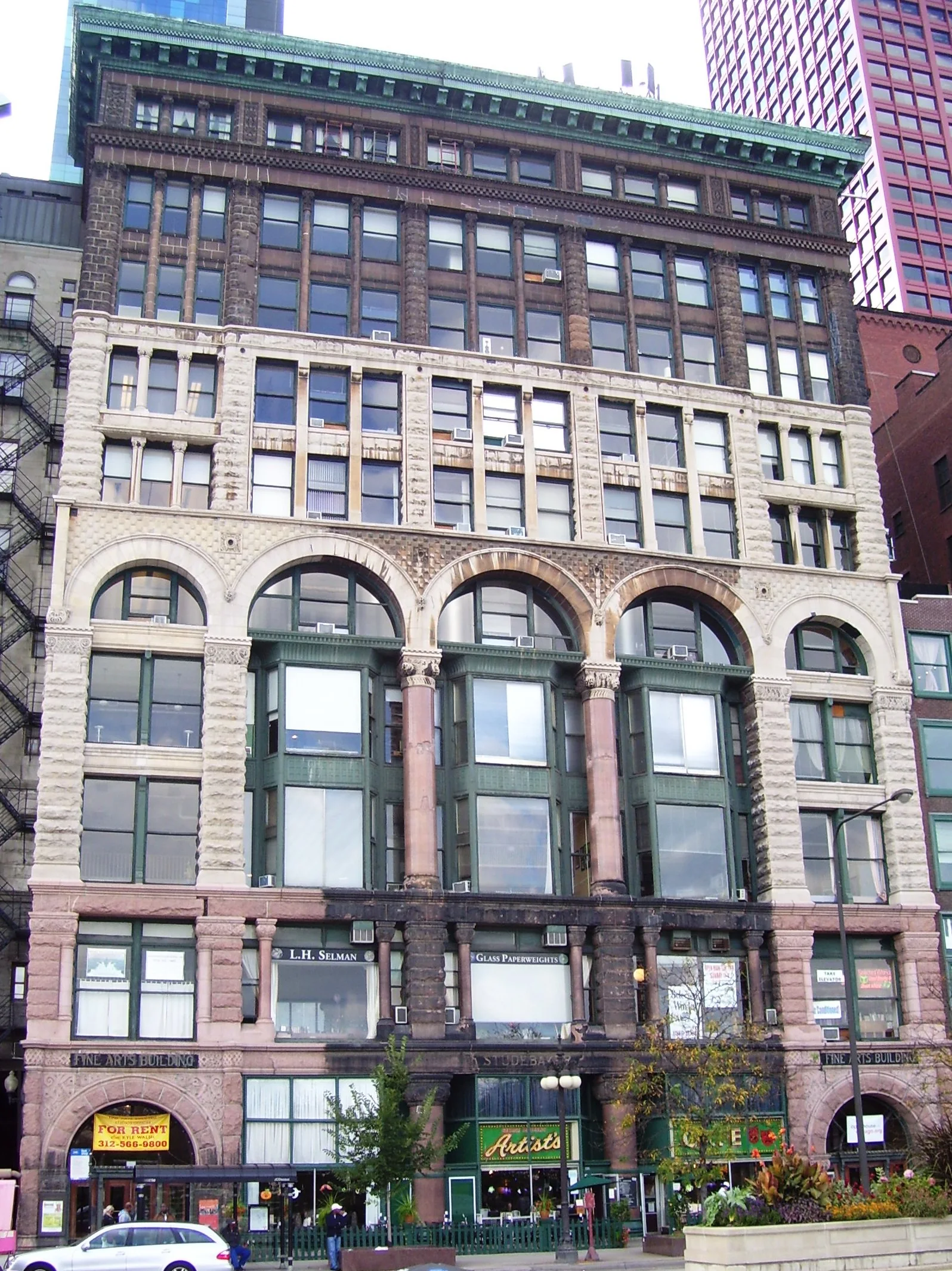 Fachada histórica do Fine Arts Building, com arcos, colunas e revestimentos contrastantes na Michigan Avenue durante o dia.