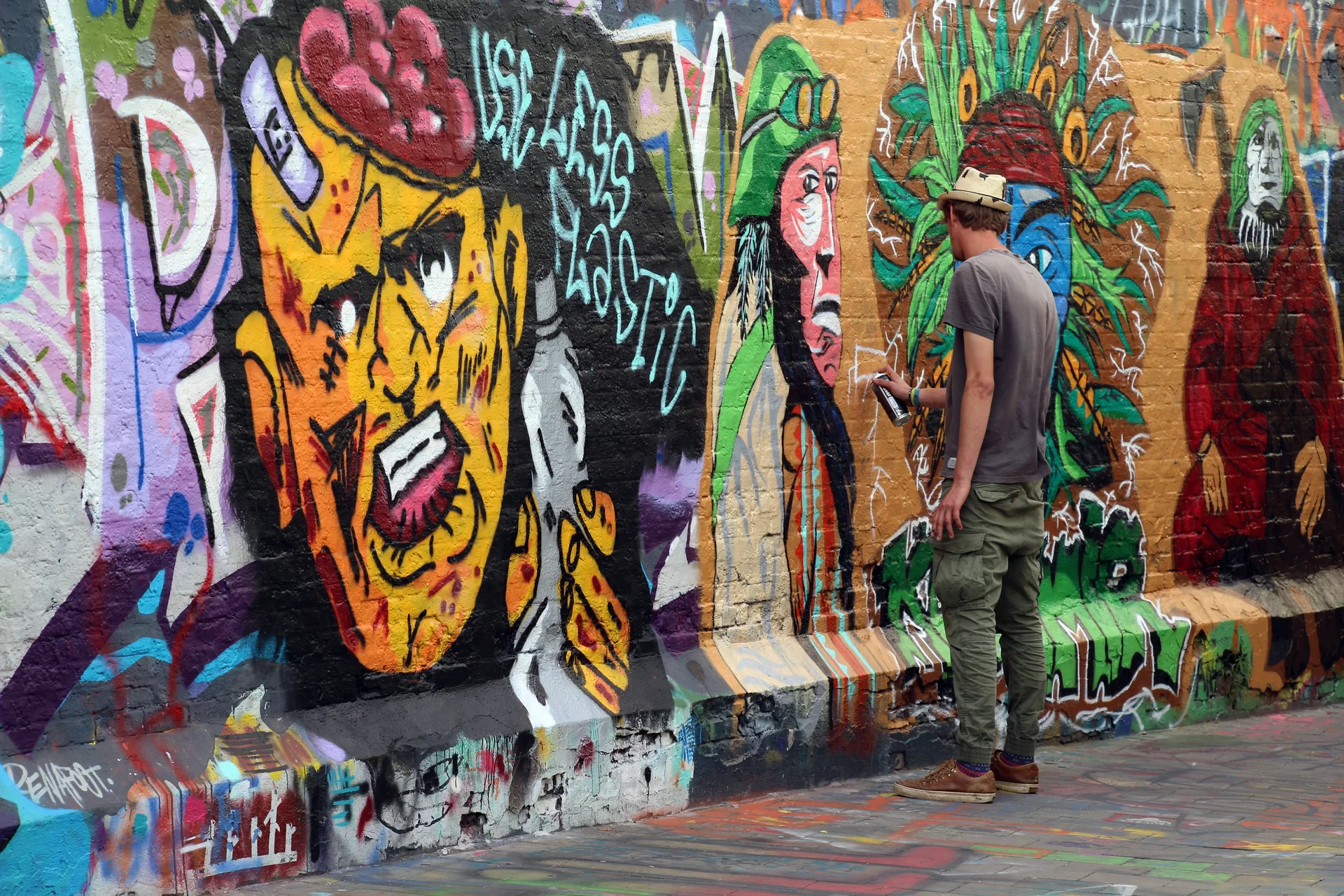 Grafites coloridos nas paredes estreitas de Werregarenstraat, a Graffiti Street de Gante, registrados em luz natural.