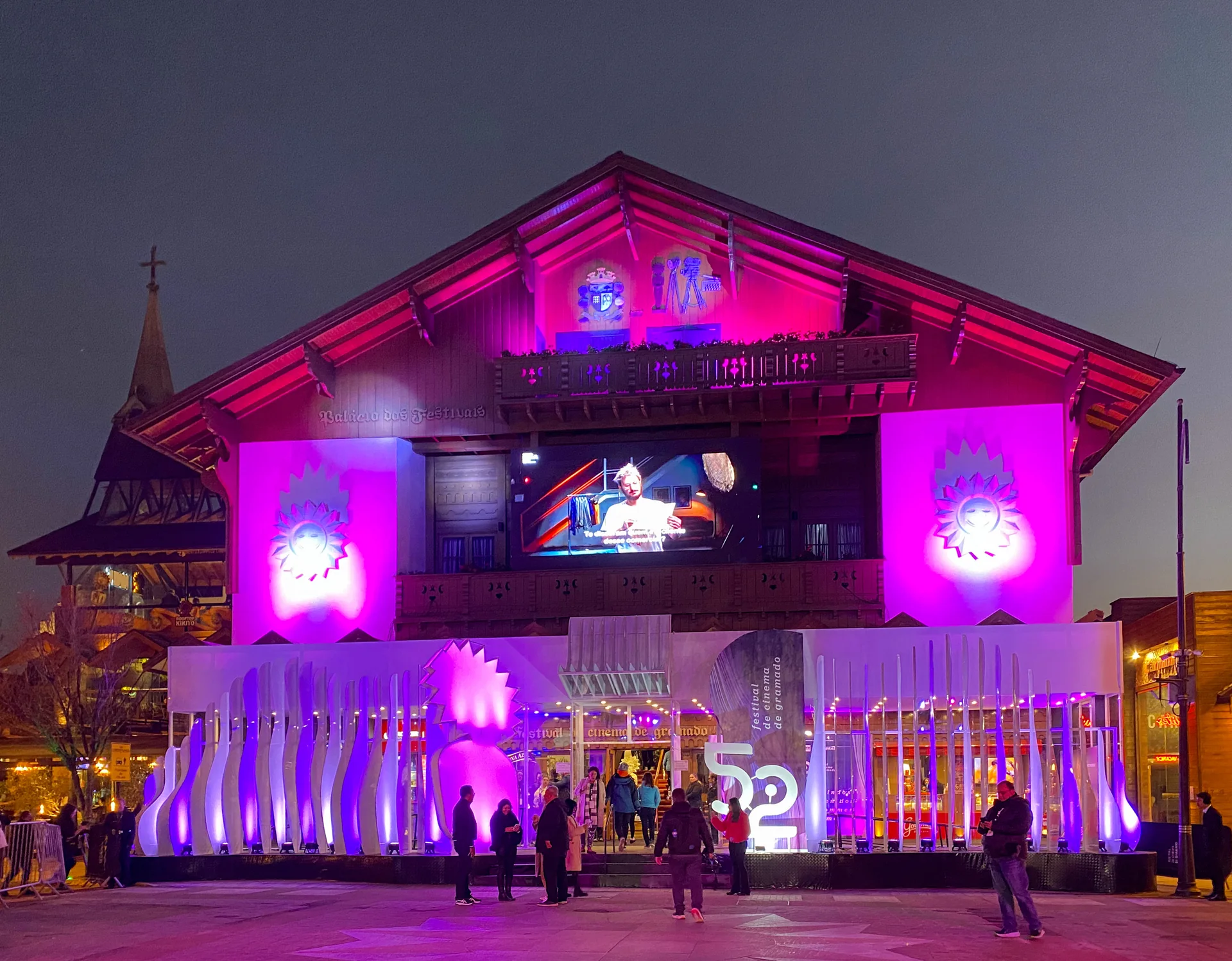 Fachada iluminada do Palácio dos Festivais durante o 52º Festival de Cinema de Gramado em 2024.